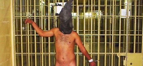 Naked hooded Iraqi man chained to bars