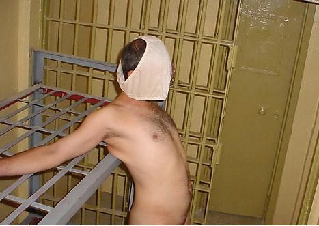 Naked chained Iraqi man with women's underwear on his head